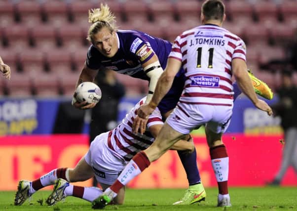 Eorl Crabtree looks for support as Sam Powell stops his run and Joel Tomkins closes in.
Wigan Warriors v Huddersfield Giants.  Super League Play-Off semi final.  DW Stadium.  1 October 2105.  Picture Bruce Rollinson