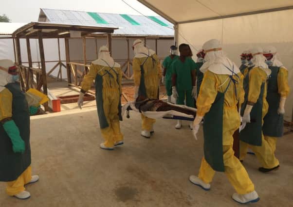 An image of aid workers helping out during the Ebola crisis in Sierra Leone.