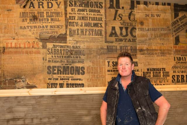 Contractor Russell Waring uncovered a wall of 130-year-old hidden posters at The Deli in Hebden Bridge. Picture: Ross Parry Agency