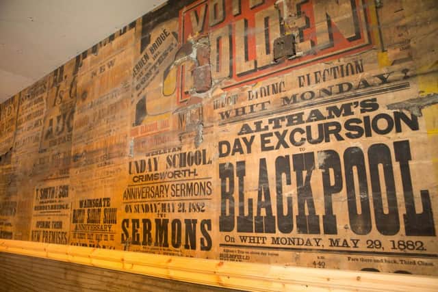 Contractor Russell Waring uncovered a wall of 130-year-old hidden posters at The Deli in Hebden Bridge. Picture: Ross Parry Agency