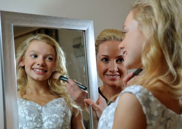 Robyn Morrison applies make up to her daughter Halle-Blu who has recently been crowned Junior Miss Galaxy UK. Picture Tony Johnson