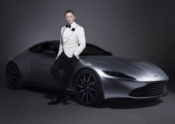 Daniel Craig with an Aston Martin DB10 which is among the James Bond memorabilia up for auction at Christie's.  MGM/PA Wire