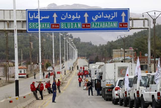 A convoy of vehicles loaded with food and other supplies organized by The International Committee of the Red Cross, working alongside the Syrian Arab Red Crescent and the United Nations makes its way to the besieged town of Madaya in Syria, about 15 miles (24 kilometers) northwest of Damascus.  (AP Photo)