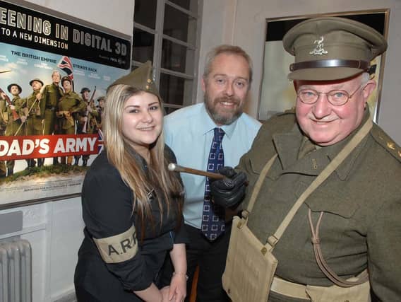 Tom Roberts in his Captain Mainwaring guise at the Harrogate premiere of Dads Army with Odeon deputy manager David Wilkinson and usherette Megan Howard. (1602052AM2)