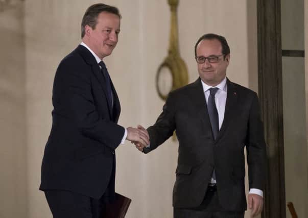 British Prime Minister David Cameron bids farewell to French President Francois Hollande after a meeting at the Elysee Palace in Paris (AP Photo/Michel Euler)