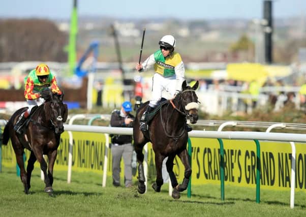 Jockey Leighton Aspell celebrates on board Many Clouds after victory in the Crabbie's Grand National last year.
