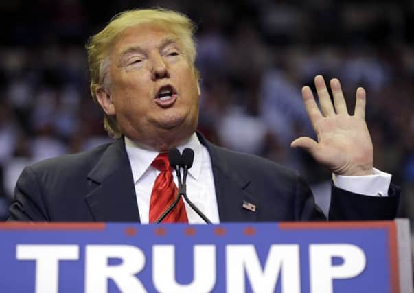 Republican presidential candidate Donald Trump gestures as he speaks to supporters during a rally.