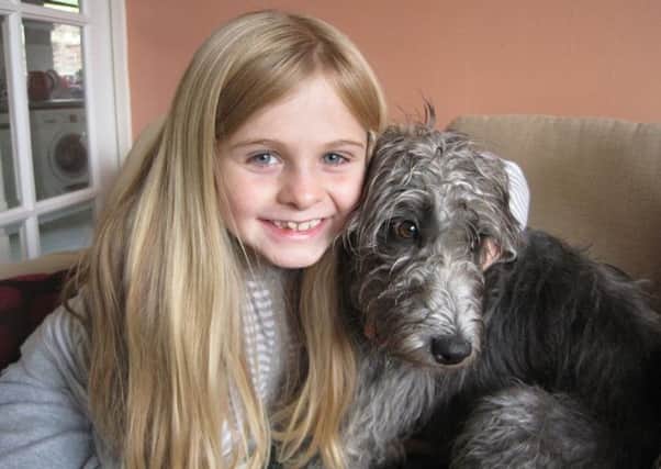 Nine-year-old Erin Taylor-Bolton with Lucy, who she borrowed via BorrowMyDoggy.com.