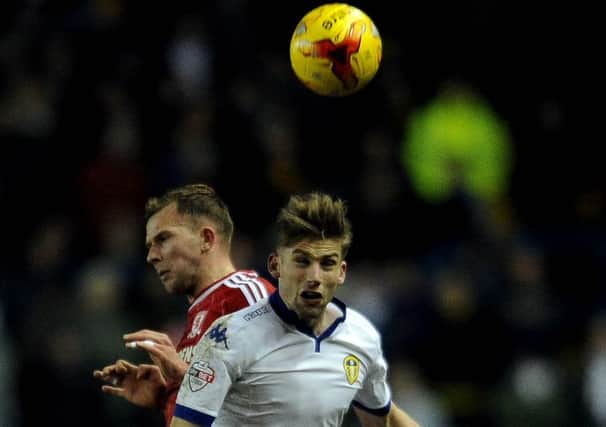 BATTLE: Leeds United's Charlie Taylor heads the ball infront of Middlesbrough's Jordan Rhodes.