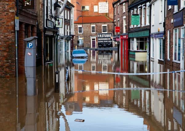 Walmgate, a popular shopping street in York is cut off as it has flooded for the first time in years.