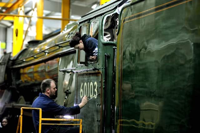 Heritage painter Mike O'Connor paints in the engine number on to the new green livery of the Flying Scotsman in a workshop at the National Railway Museum in York. Picture: James Hardisty