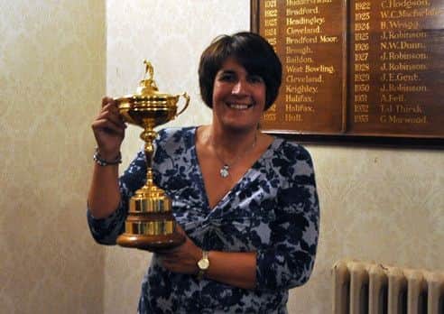 Huddersfield GC member and travel trip organiser Anita Mandl, pictured holding the Ryder Cup during a charity event at Fixby.