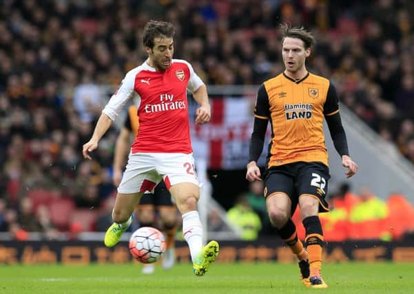 Hull City's Nick Powell and Arsenal's Mathieu Flamini (left) in action.
