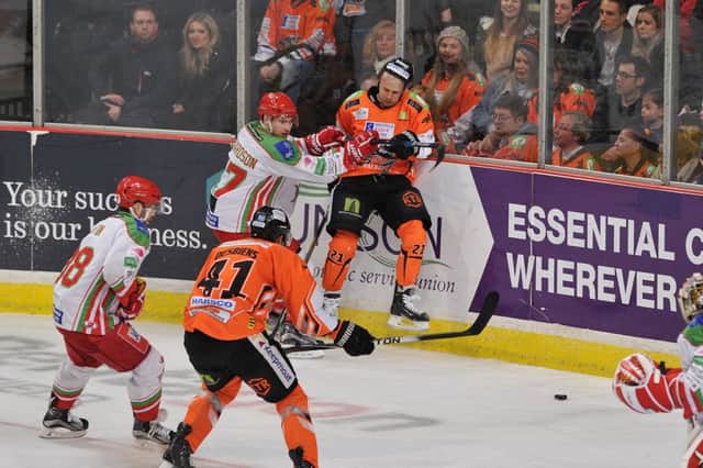 ROUGH TIME: Steelers' hat-trick man Tyler Mosienko is sent up against the boards by Cardiff's Mark Richardson. Pictures: Dean Woolley.