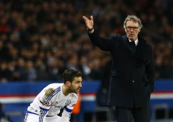 PSG head coach Laurent Blanc, right, gestures as Cesc Fabregas collects the ball for a throw in during the Champions League match between Paris Saint Germain and Chelsea at the Parc des Princes last Tuesday.