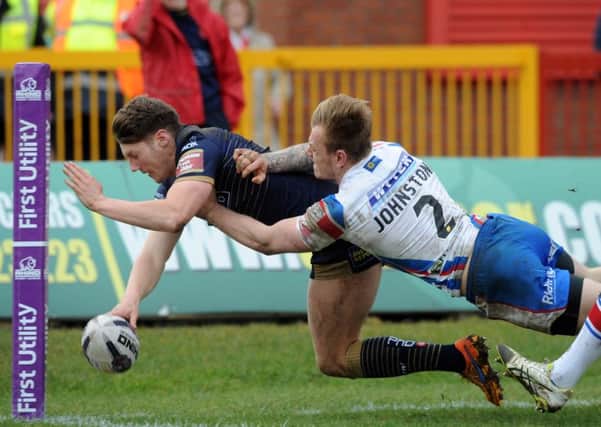 Hull Kingston Rovers' Ryan Shaw dives to make a try but fails after he is pushed off the field by Wakefield's Tom Johnstone.