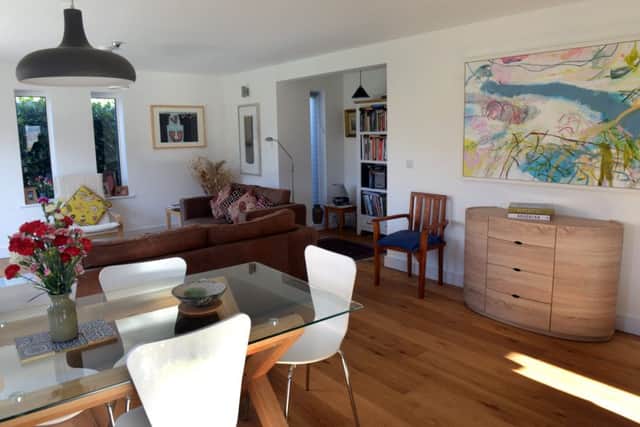 The open plan living space is filled with art work. The dining table was a bargain from Achica