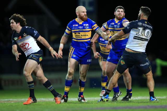 Leeds Rhinos' Mitch Garbutt, second right, punches North Queensland Cowboys James Tamou, resulting in a red card during the World Club Series match at Headingley. Picture: Mike Egerton/PA.