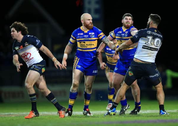 Leeds Rhinos' Mitch Garbutt, second right, punches North Queensland Cowboys James Tamou, resulting in a red card during the World Club Series match at Headingley. Picture: Mike Egerton/PA.