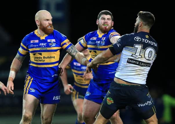 Leeds Rhinos' Mitch Garbutt (second right) punches North Queensland Cowboys James Tamou in the World Club Challenge last night
