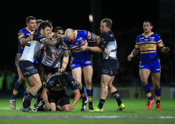 Leeds Rhinos' Mitch Garbutt (left) punches North Queensland Cowboys James Tamou (floor), resulting in a red card.