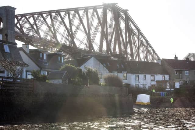 Police at the scene on the coastline at North Queensferry on the Firth of Forth, near the Forth Rail Bridge, where a body has been found in the search for a missing teenager Jasmine Macquaker, 14, who disappeared on Sunday night.  Photo:  South West News Service