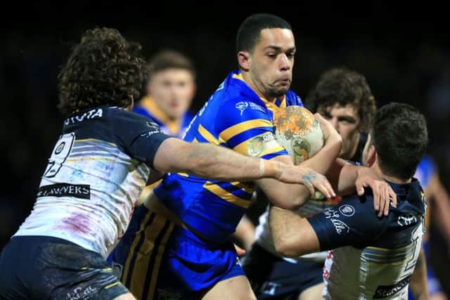 North Queensland Cowboys' Jake Granville, left, and Lachlan Coote tackle Leeds Rhinos' Josh Walters at Headingley.