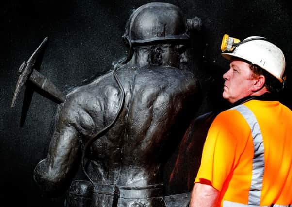 Former miner Ian Cunniff, who worked at Kellingley Colliery for 11 years, with the Miners' Memorial at the National Coal Mining Museum near Wakefield. Picture: James Hardisty.