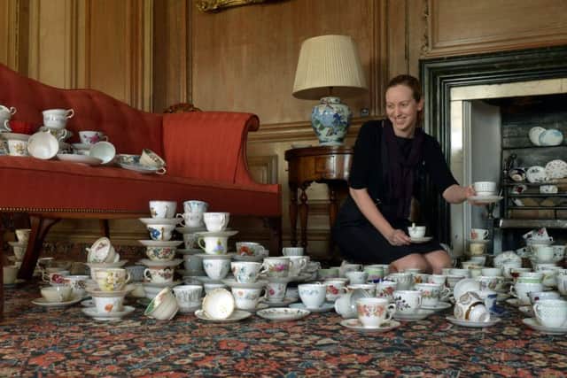 Clare Alton-Fletcher exhibitions manager for the National Trust York, helping to set out 300 teacups, one for every year of Beningbrough Hall