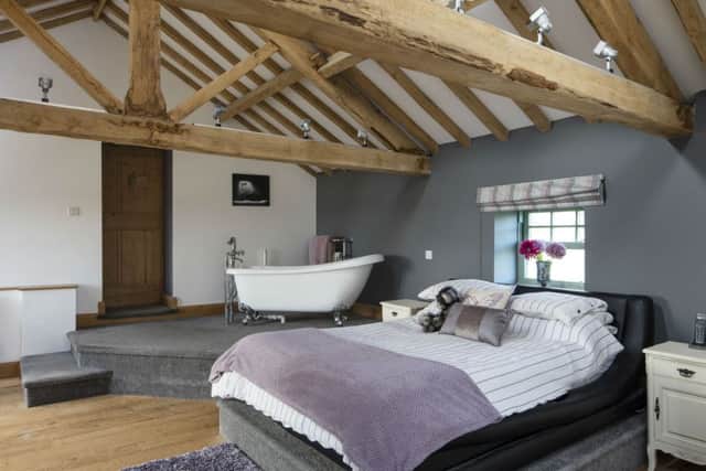 The master bedroom with a bath positioned to soak up the rural view