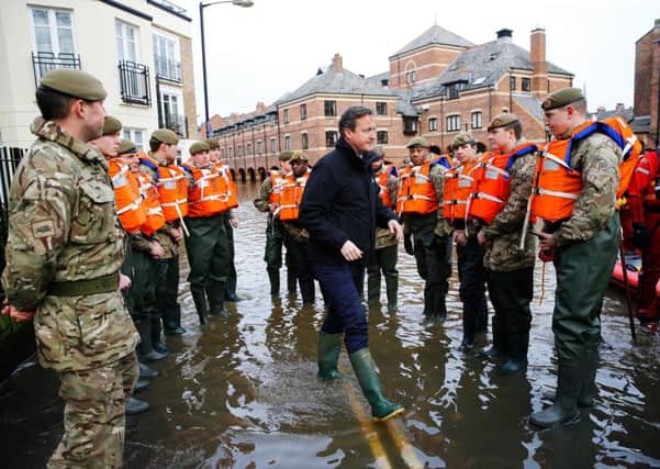 Prime Minister David Cameron greets soldiers working on flood relief in York city centre after the river Ouse burst its banks.