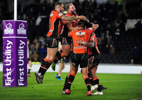 YOU BEAUTY: Castleford's players mob Denny Solomona after he scored his hat-trick try late on. Picture: Jonathan Gawthorpe