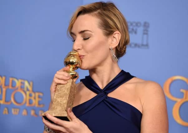 Kate Winslet, the focus of a new debate on social mobility, poses in the press room with the award for best performance by an actress in a supporting role in a motion picture for Steve Jobs at the 73rd annual Golden Globe Awards.