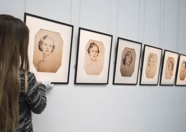 A Sotheby's employee adjusts After William Acton The Mitford Sisters, six reproduction prints which will be auctioned during Sotheby's forthcoming Deborah, Duchess of Devonshire, The Last of The Mitford Sisters sale. Photo: Lauren Hurley/PA Wire