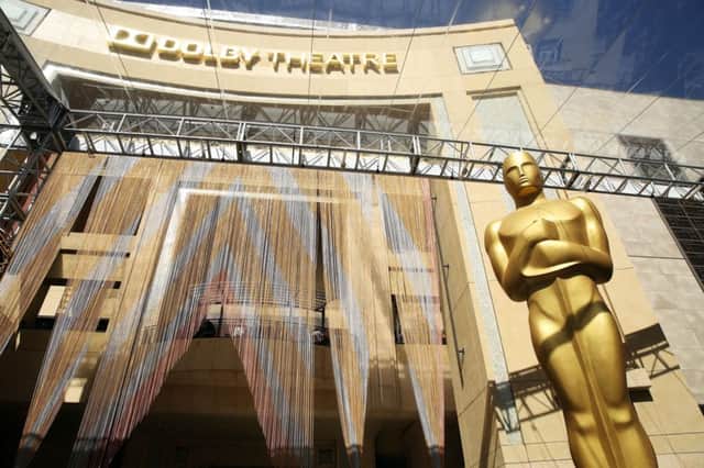 An Oscar statue appears outside the Dolby Theatre in preparation for the 88th Academy Awards in Los Angeles