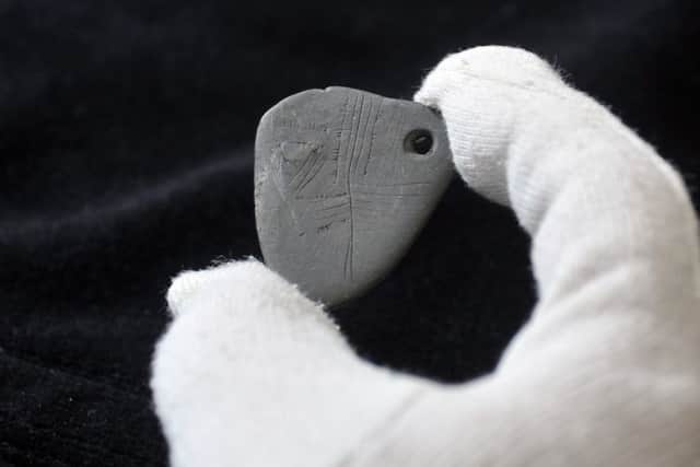 An 11,000 year old pendant, the earliest known piece of Mesolithic art in Britain, may have been worn by a shaman, according to researchers.