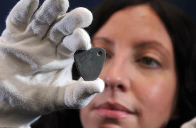 Natalie McCaul, Curator of Archeology at the Yorkshire Museum, with the 11,000 year old pendant that is the earliest known Mesolithic art in Britain.  Picture: Tony Johnson