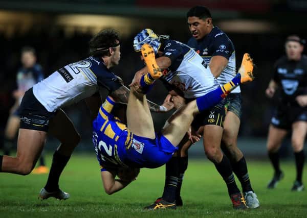 North Queensland Cowboys Ethan Lowe, left, and Johnathan Thurston force Leeds Rhinos' Ash Handley to the ground during last Sunday's World Club Challenge match at Headingley. Picture: PA.