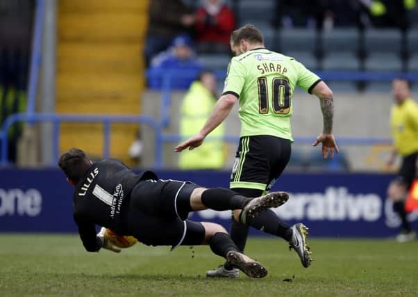 Rochdale goalkeeper Josh Lillis dives at the feet of Sheffield Uniteds Billy Sharp to deny the striker (Picture: Sport Image).