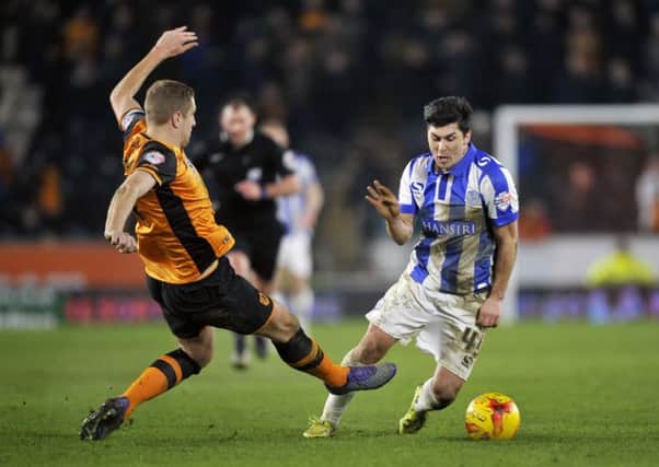Fernando Forestieri goes down under the challenge of Hull Citys Michael Dawson. The Sheffield Wednesday forward was subsequently sent off again for taking an alleged dive (Picture: Steve Ellis).