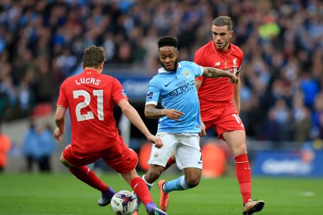 Liverpool's Lucas Leiva and Jordan Henderson (right) battle for the ball with Manchester City's Raheem Sterling (centre) during the Capital One Cup final at Wembley. Picture: PA.