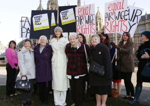 Gemma Arterton (centre) with original Dagenham women strikers (front row left to right) Gwen Davis, Eileen Pullen, Vera Sime and Sheila Douglass, and cast of the musical Made in Dagenham during a photocall with original Dagenham ladies outside the Houses of Parliament, London, to coincide with a Labour bid to force big firms to publish the difference in pay between male and female employees.