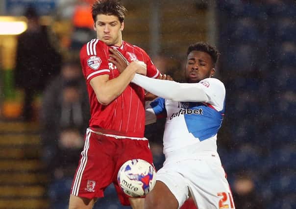 Middlesbrough's George Friend, left, battles for the ball with Blackburn Rovers' Hope Akpan (Picture:: Martin Rickett/PA Wire).