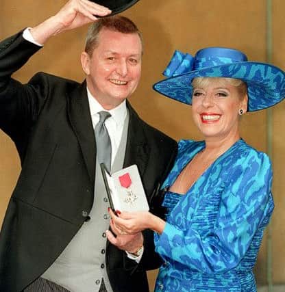 Tony Warren with actress Julie Goodyear outside Buckingham Palace after he received his MBE