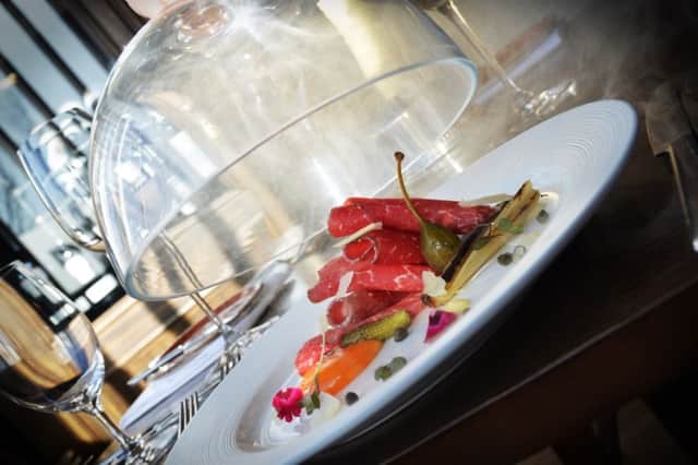The beef carpaccio, which unexpectedly came served under a glass cloche filled with applewood smoke, worked fantastically.