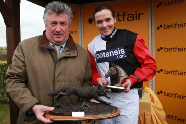Paul Nicholls (left) and Victoria Pendleton with the Dick Woodhouse Trophy after winning the Betfair Switching Saddles Hunter Chase at Wincanton. Picture: David Davies/PA.