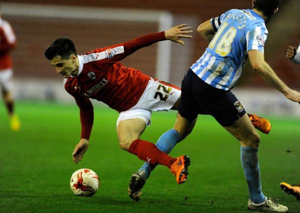 IN-FORM REDS: Barnsley defender George Williams is taken down by Coventrys Sam Ricketts. Picture: Bruce Rollinson.