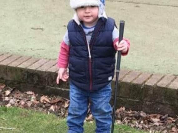 Eighteen-month-old James Pearson with his first golf club.