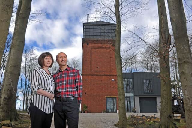 Carol and Majid Nadry at the side of the tower, showing the rear double-height extension
. 
Picture Tony Johnson