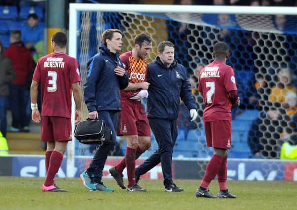 Bantams' Rory McArdle leaves the pitch injured.  Picture Tony Johnson